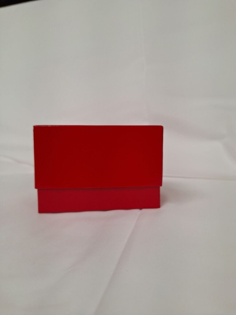a red box sitting on top of a white sheet