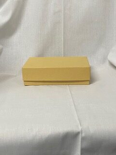 a yellow box sitting on top of a white sheet