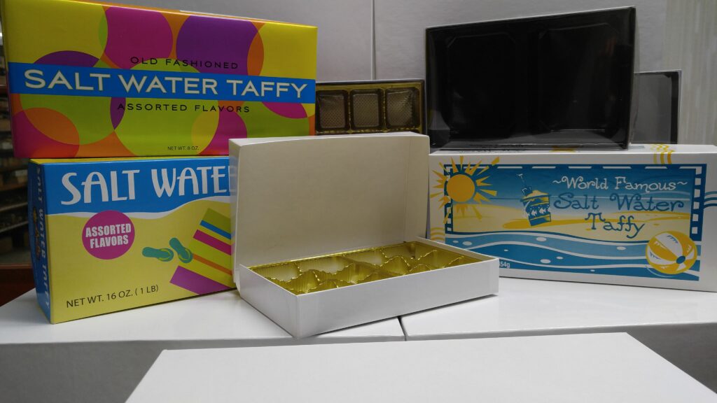 three boxes of salt water taffy sitting on a table