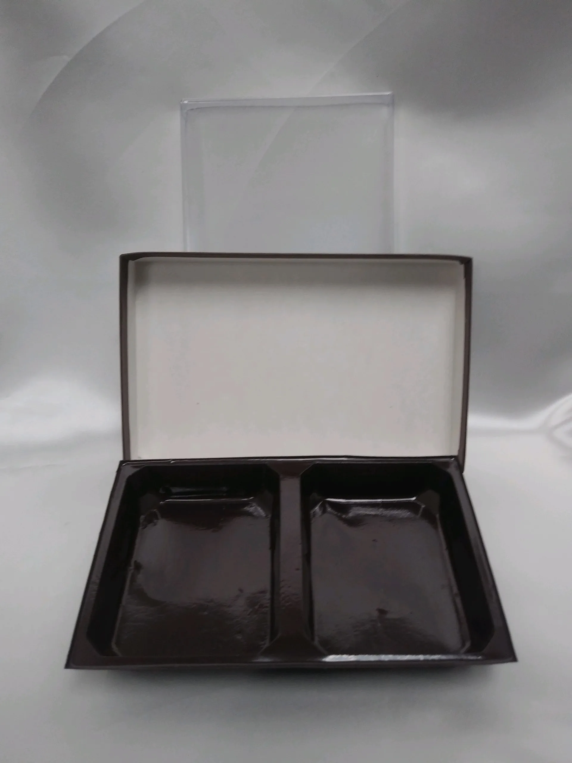 Interior of a black and white candy box with two inserts