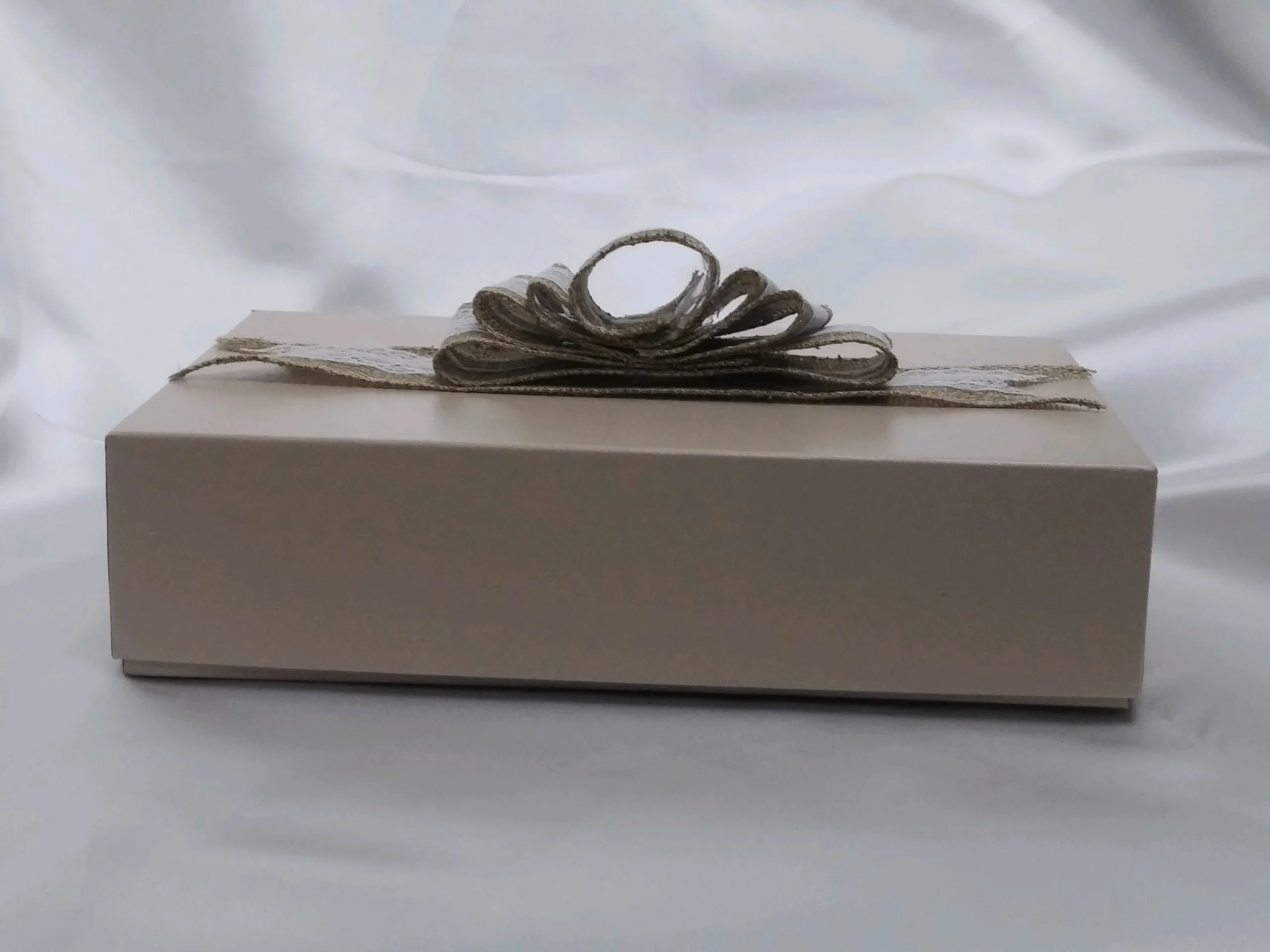 a white box with a ribbon tied around it