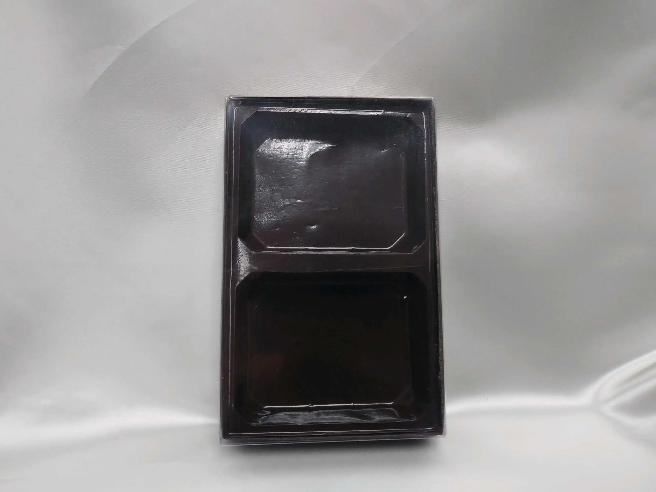 Exterior of a black candy box with two inserts